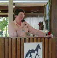 Sue Millard on the speaker's rostrum in the Hall of Champions